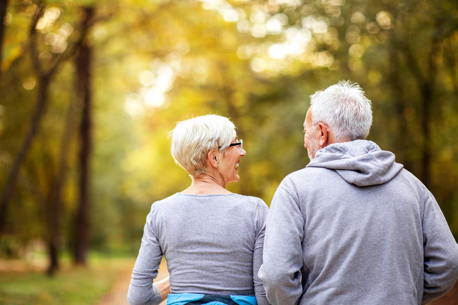 Mature couple jogging together outdoors, feeling like themselves again