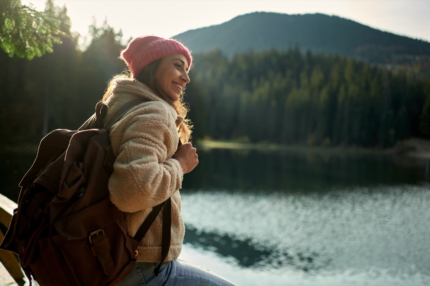 Woman at a Utah mountain lake in warm evening light, calm and at ease